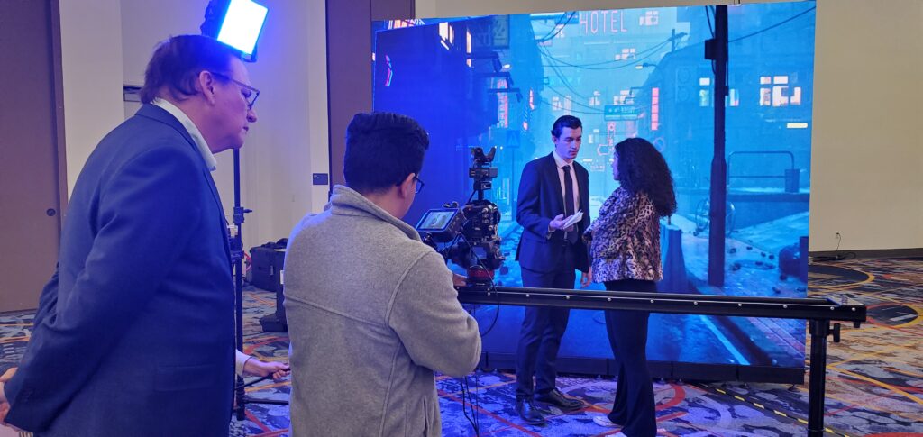 Students from UNLV practice virtual production on a small LED wall at NAB 2023
